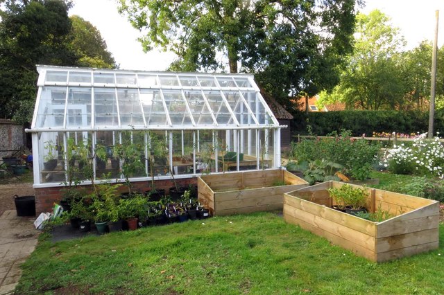 A greenhouse in a garden.